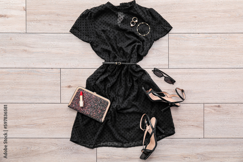 Black dress with accessories, heels and lipstick on light wooden floor