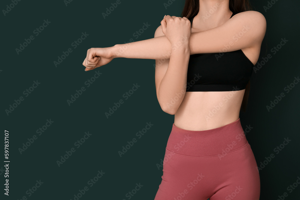 Sporty young woman on green background, closeup