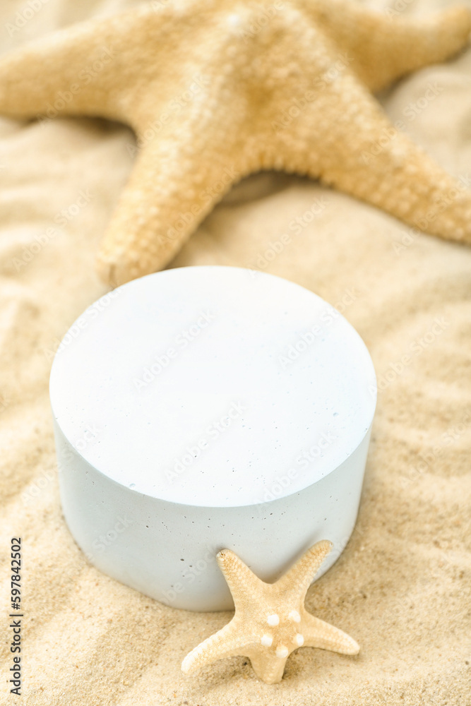 Decorative plaster podiums and starfishes in sand