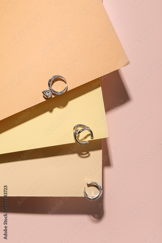 Paper sheets with golden rings on beige background