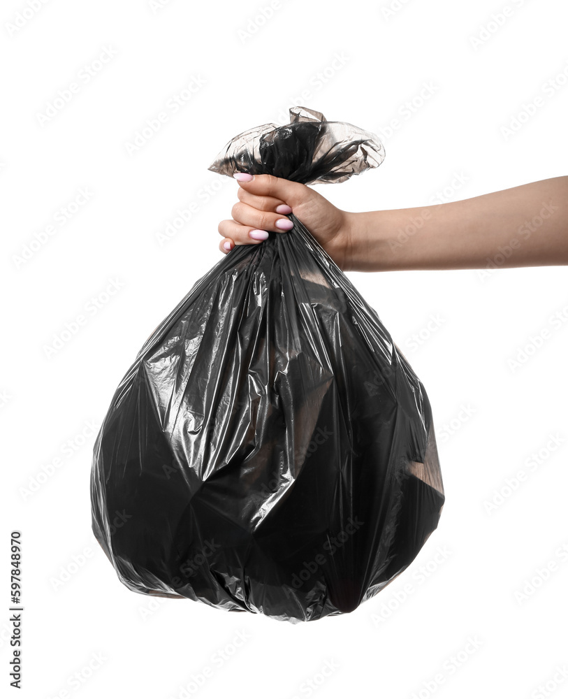 Female hand holding full garbage bag isolated on white background