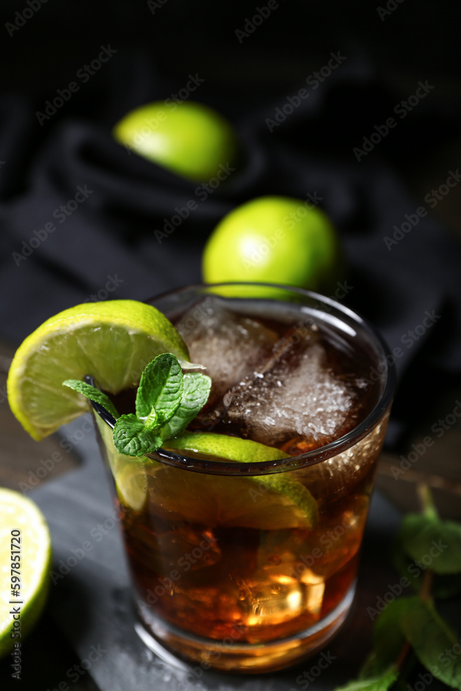 Glass of tasty Cuba Libre cocktail on table