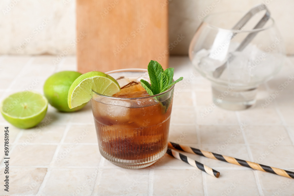 Glass of tasty Cuba Libre cocktail on table