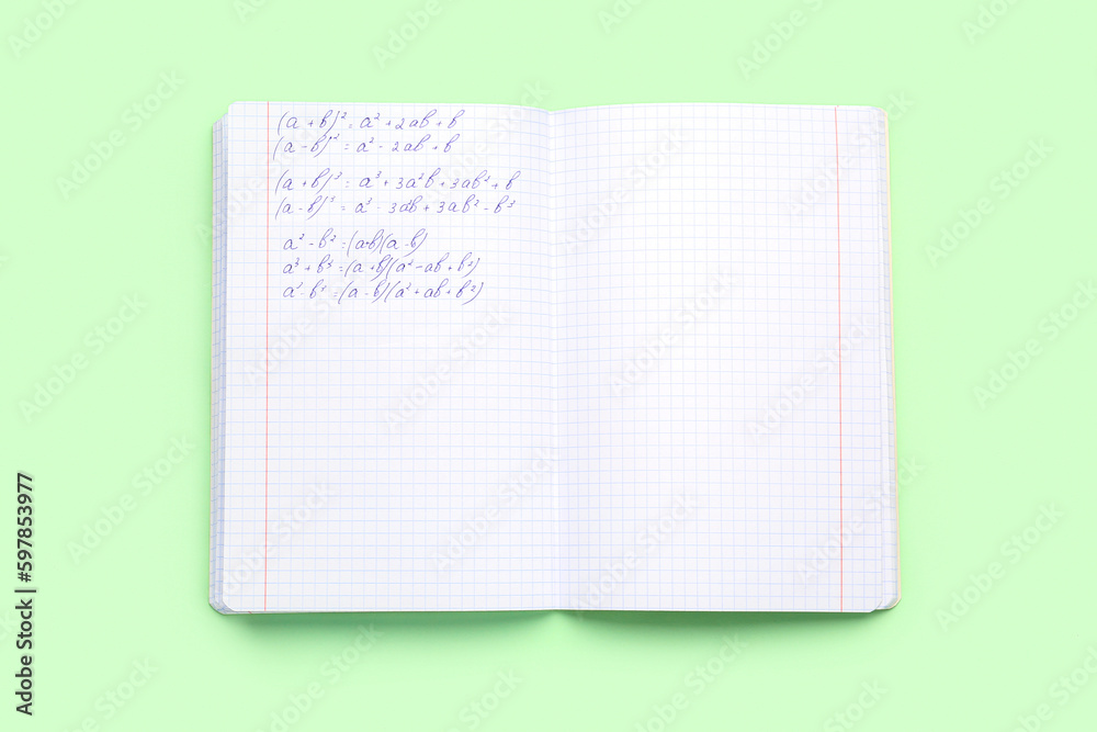 Copybook with maths formulas on green background