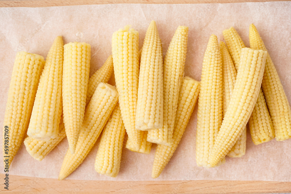 Tasty canned corn cobs on table