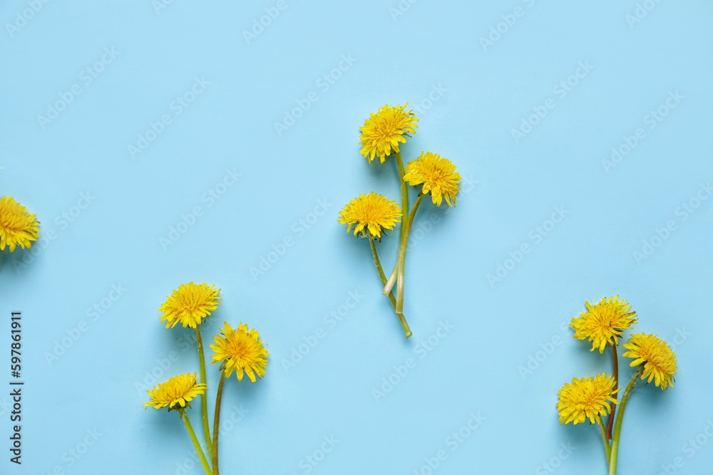 Bright yellow dandelions on blue background