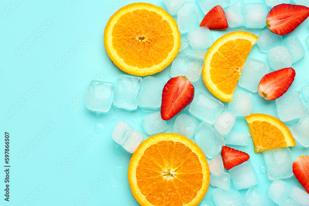 Sliced fresh orange with strawberry and ice cubes on turquoise background