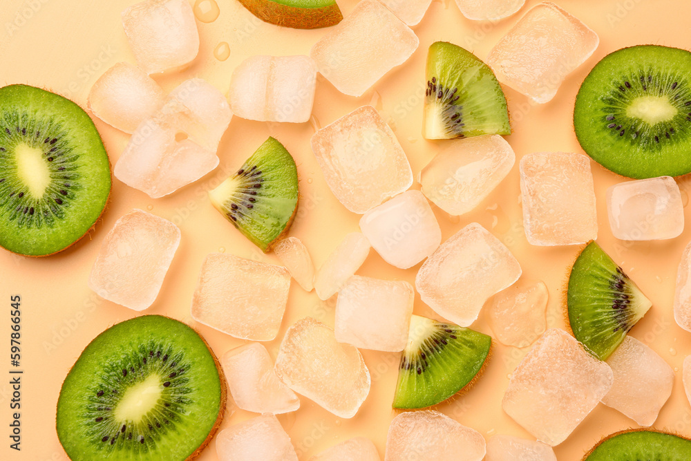 Sliced fresh kiwi and ice on orange background