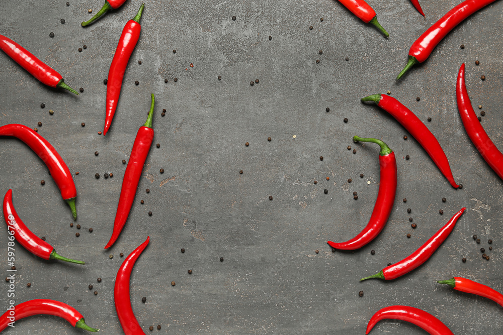 Frame made of fresh chili peppers and peppercorns on dark background