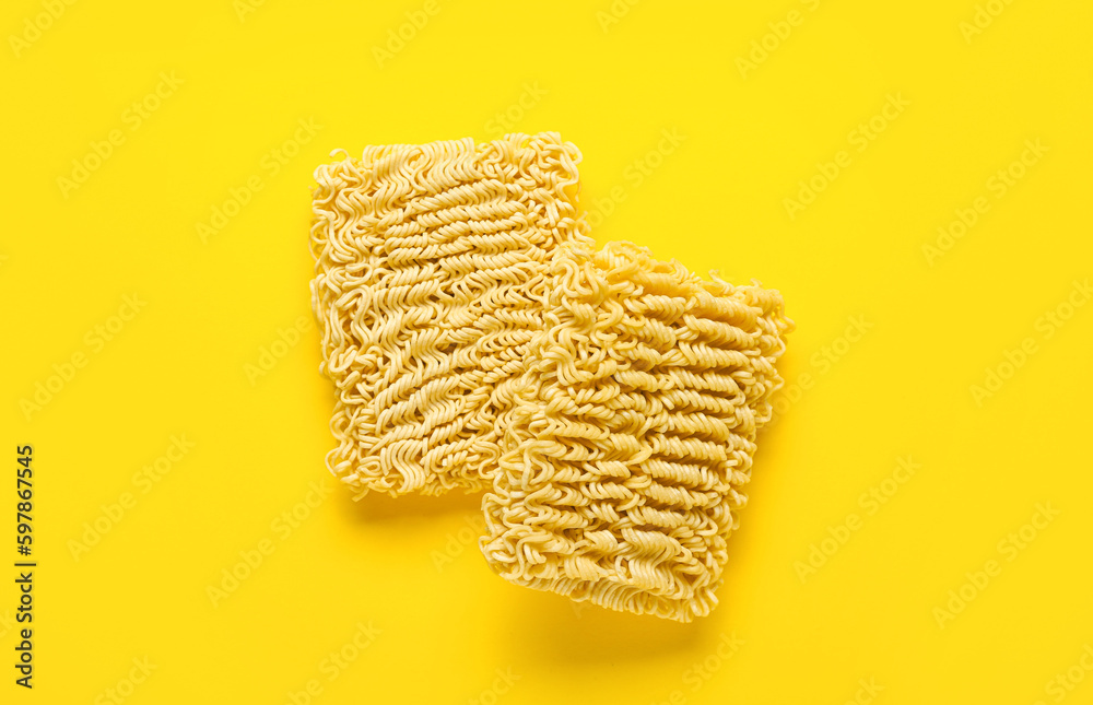 Raw instant noodles on yellow background