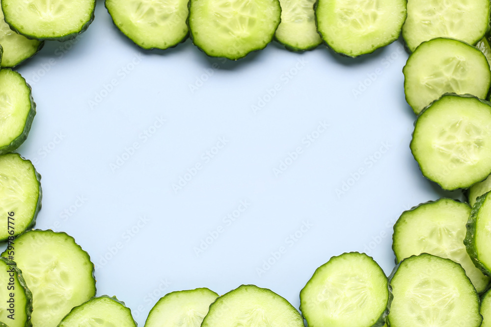 Frame made of sliced cucumber on blue background