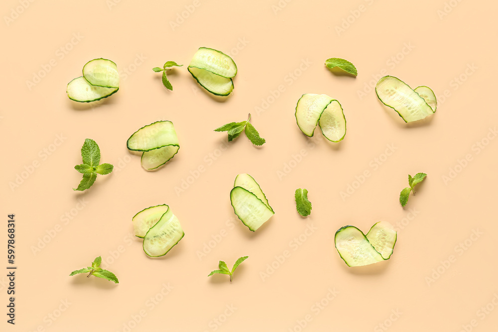 Slices of cucumber with mint on beige background