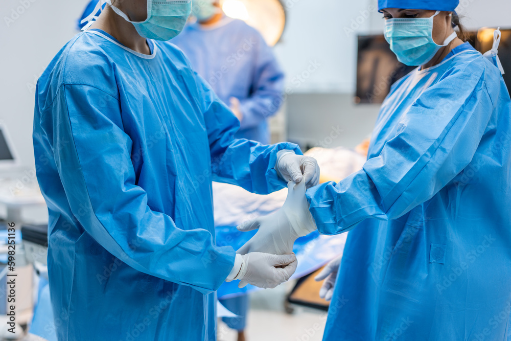 Professional doctors performing surgical operation in operating room. 