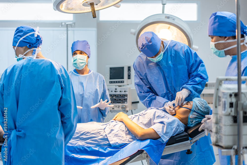 Professional doctors performing surgical operation in operating room. 