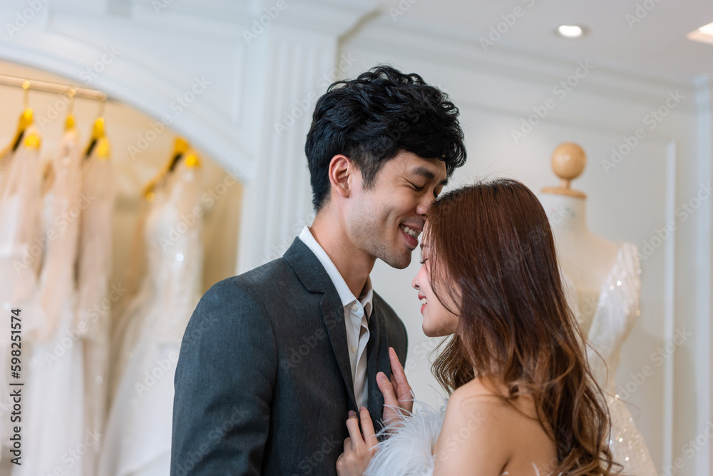 Asian attractive fiance couple kissing each other in wedding studio. 