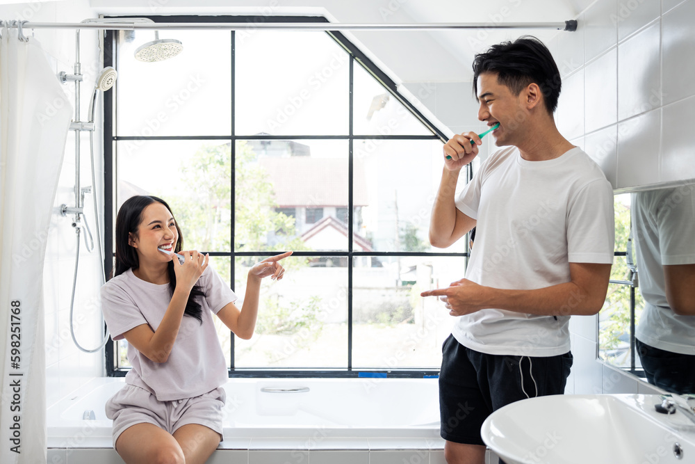 Asian new marriage couple brushing teeth together in bathroom at home. 