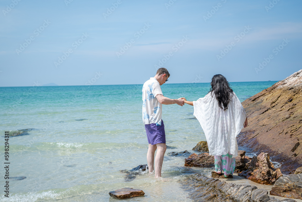 Fun,Holiday,Couple happy on vacation having fun by the sea.