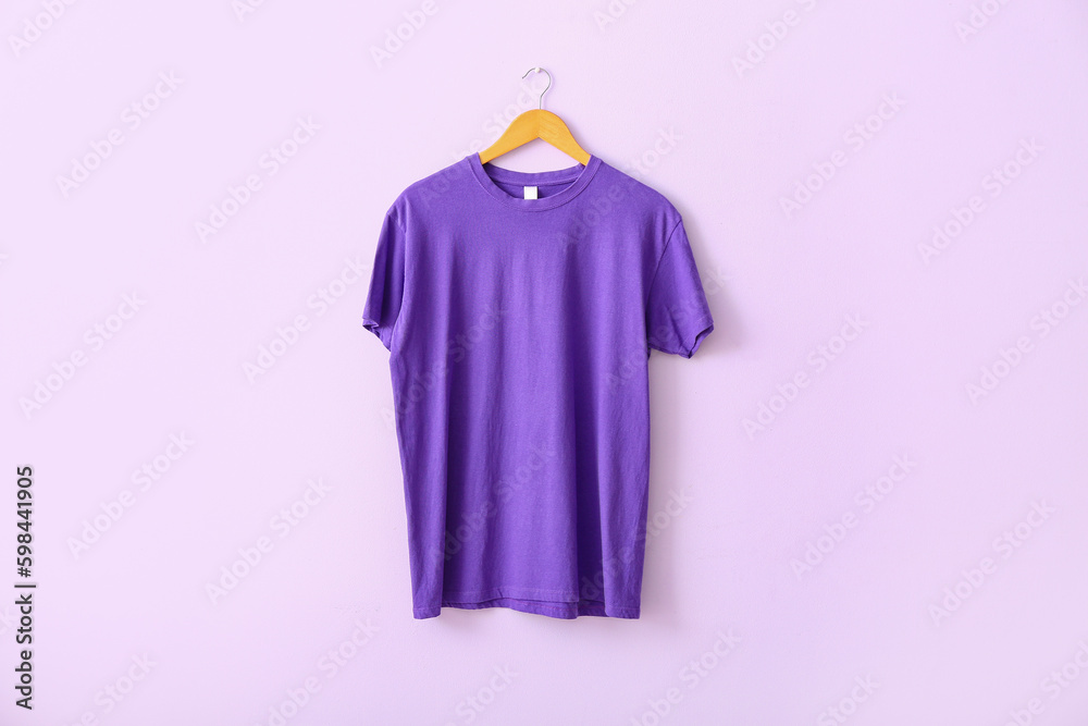 Purple t-shirt hanging on lilac wall