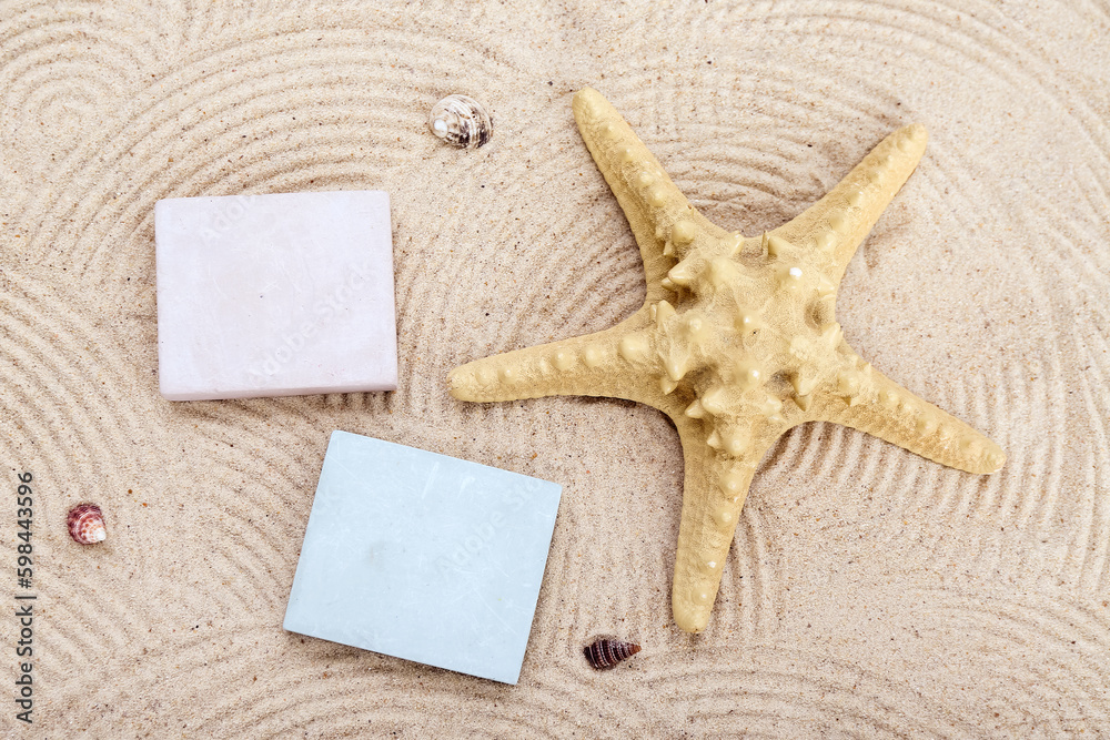 Decorative plaster podiums, starfish and seashells in sand