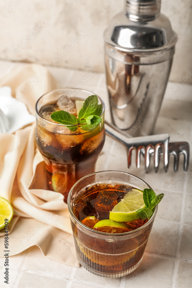 Glasses of tasty Cuba Libre cocktail on table