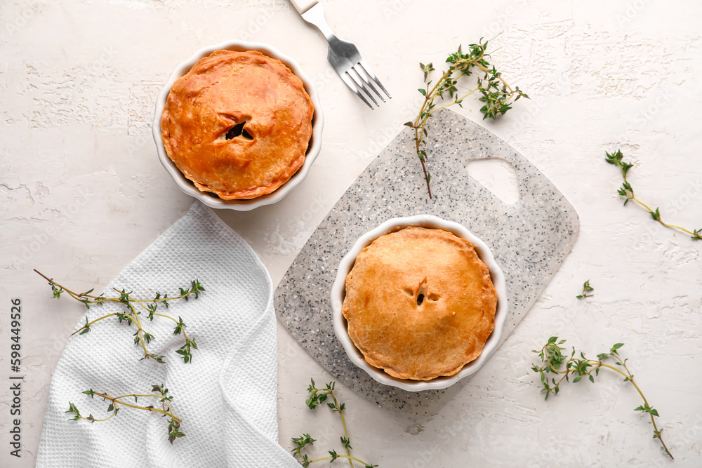 Tasty meat pot pies on light background