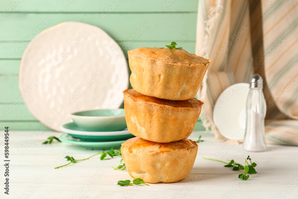 Tasty meat pot pies on table