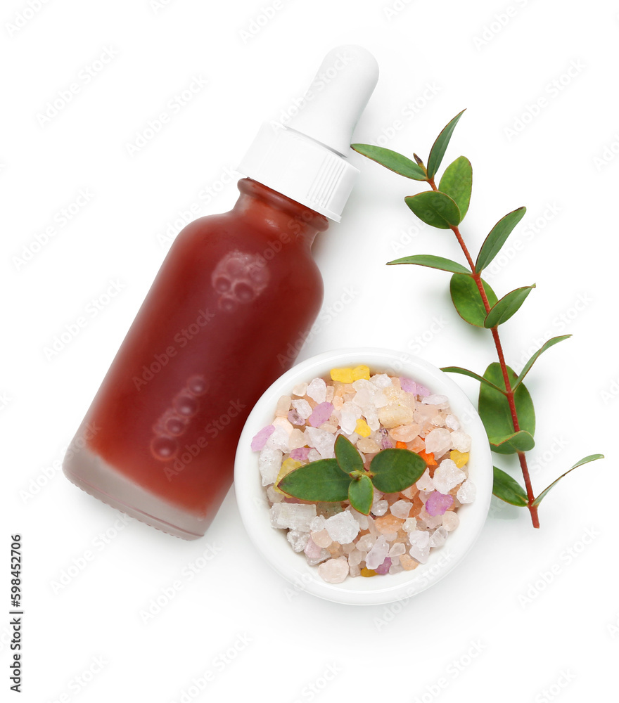 Bottle of cosmetic oil with eucalyptus twig and bowl of sea salt on white background