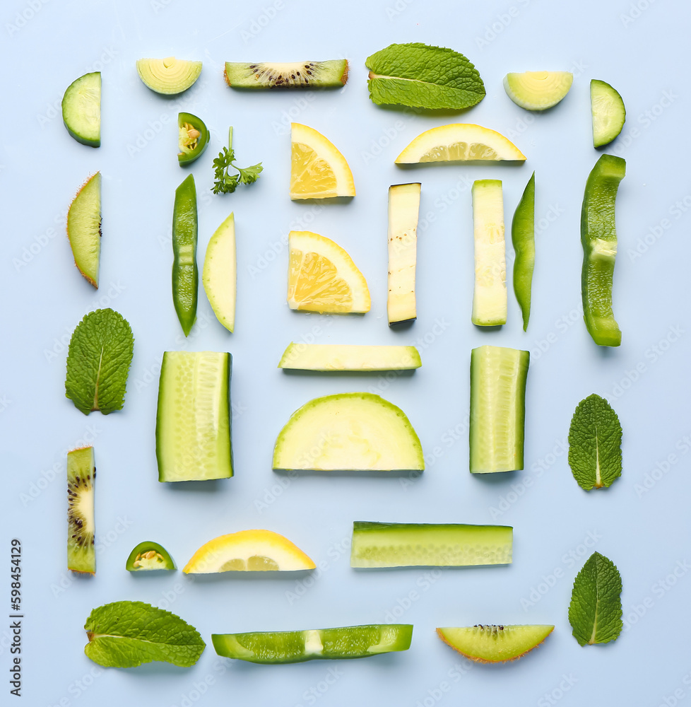 Composition with green fresh fruits and vegetables on blue background