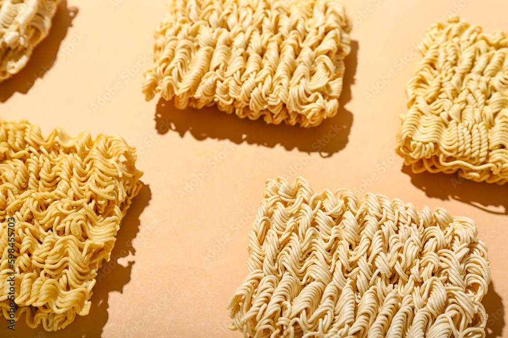 Raw instant noodles on beige background