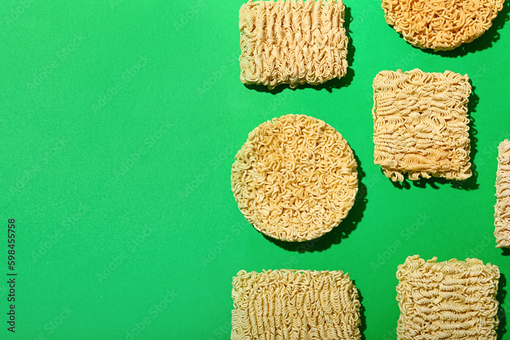 Raw instant noodles on green background