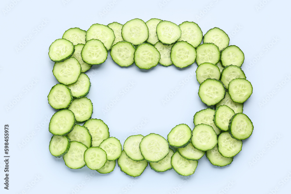 Frame made of sliced cucumber on blue background