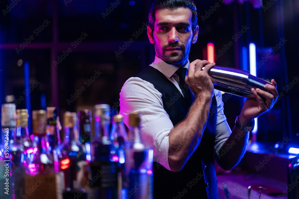 Caucasian profession bartender making a cocktail for women at a bar. 