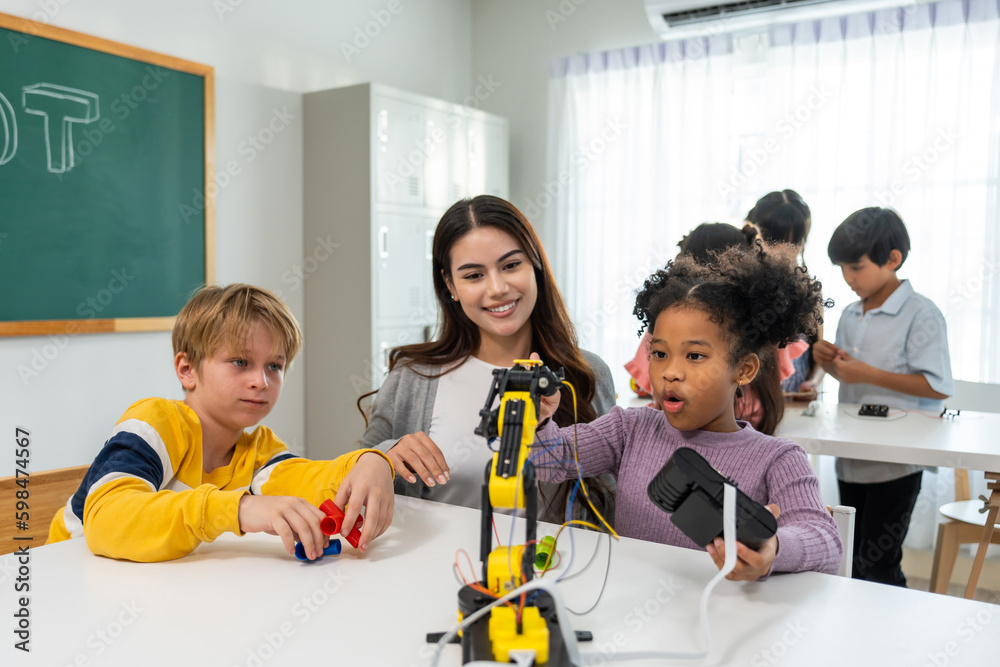 Caucasian woman teacher teaching a lesson to kids at elementary school. 