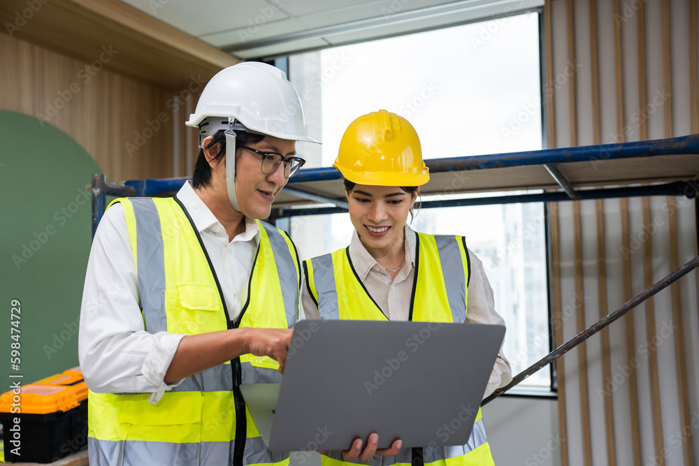 Asian young businessman and businesswoman working in construction site. 