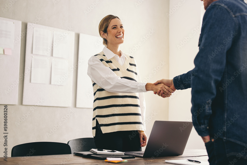 New business partners shaking hands in an office