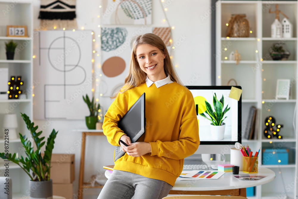 Female graphic designer with tablet in office