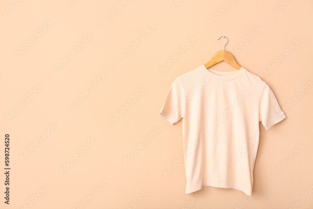 White t-shirt hanging on light wall