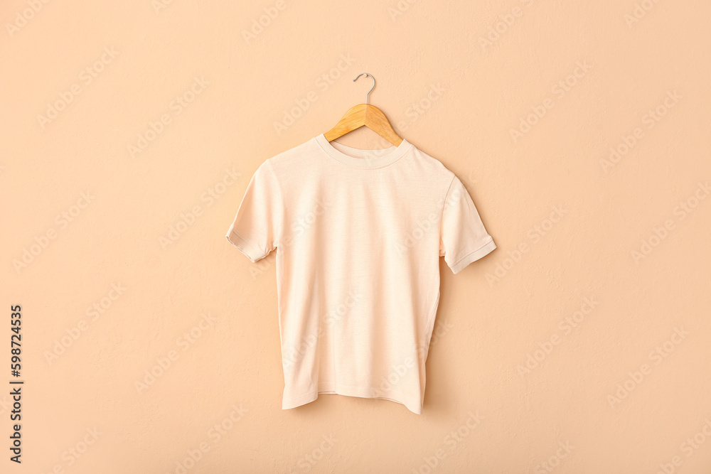 White t-shirt hanging on light wall