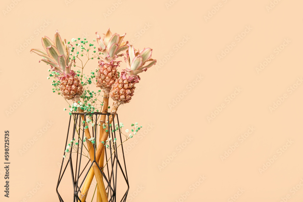 Vase with decorative pineapples on beige background, closeup