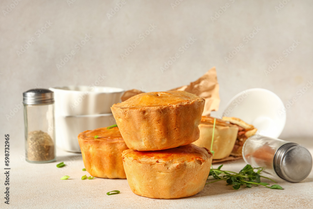 Tasty meat pot pies on light background