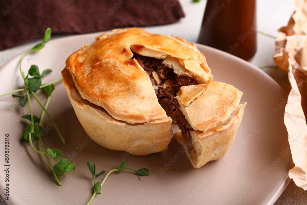 Plate with tasty meat pot pie on table