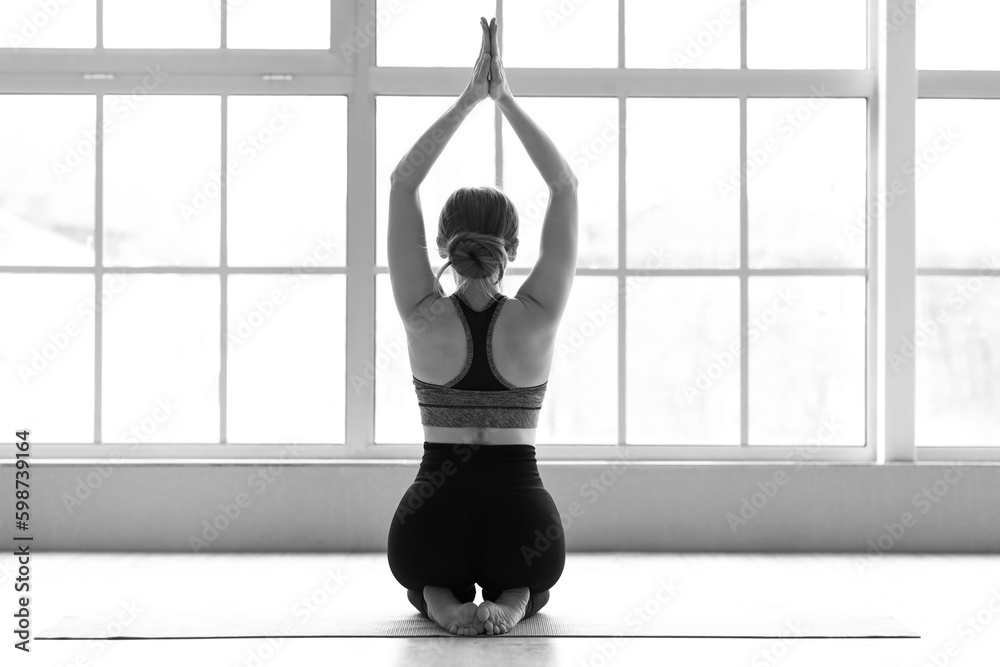 Sporty young woman doing yoga  in gym