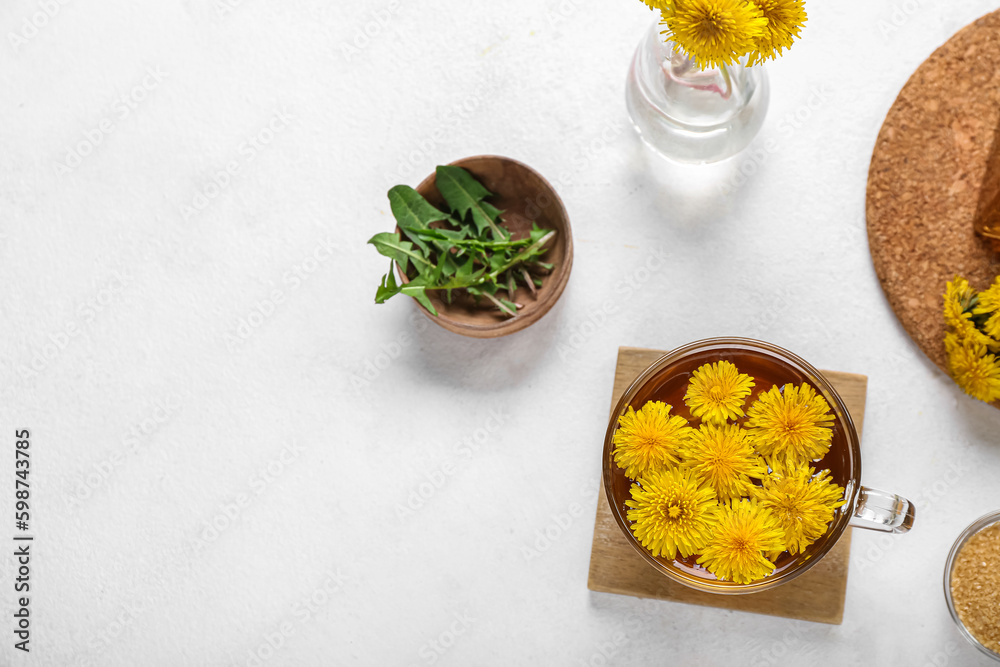 Glass cup of healthy dandelion tea on white background