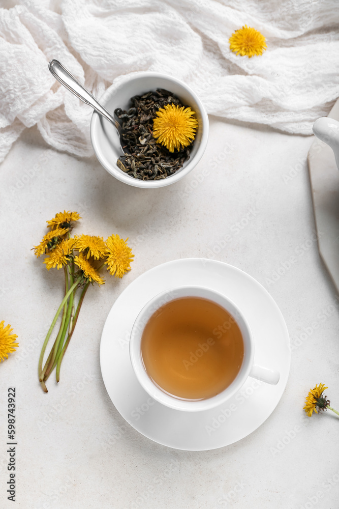 Cup of healthy dandelion tea on white background