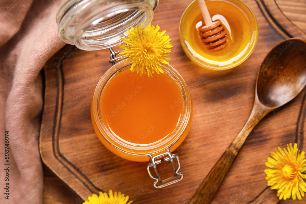 Jar and bowl with dandelion honey as background, closeup