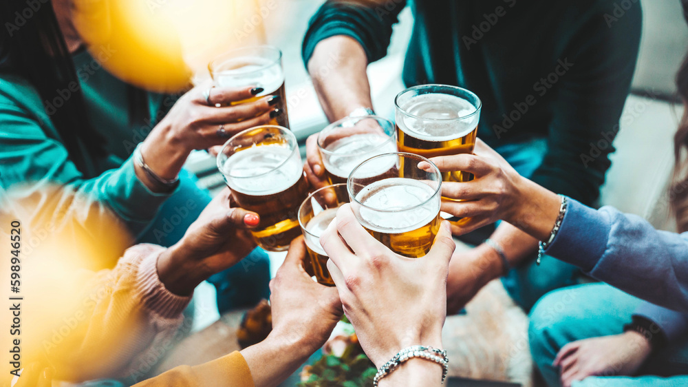 Group of people drinking beer at brewery pub restaurant - Happy friends enjoying happy hour sitting 