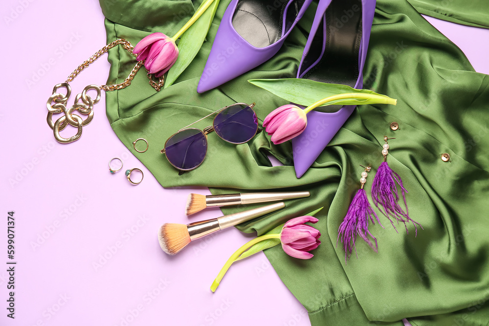 Composition with stylish female accessories, makeup brushes, heels and tulip flowers on color backgr