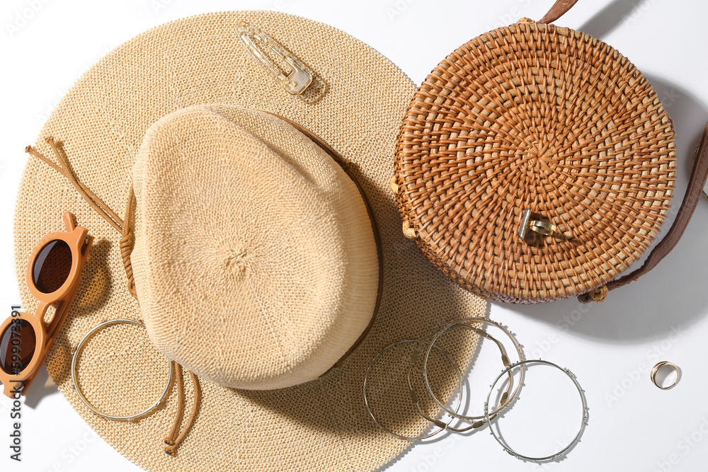 Jewelry with sunglasses, bag and summer hat on white background