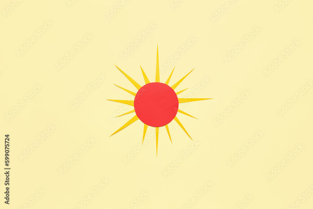 Bright paper sun on yellow background