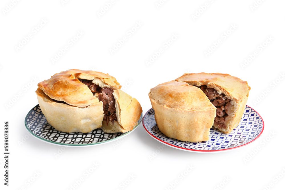 Plates with tasty meat pot pie on white background